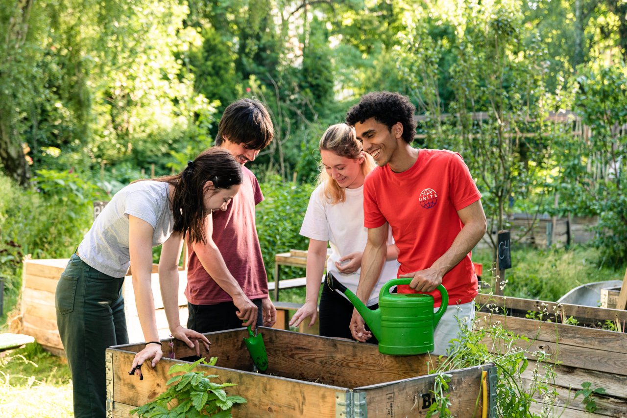 Jugendliche beim Gärtnern an einem Hochbeet